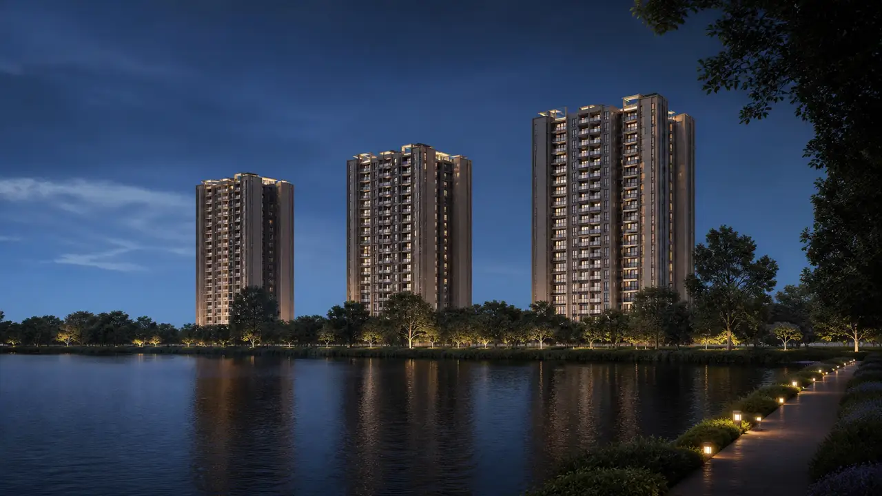 Green lake edge with three residential towers visible beyond planting